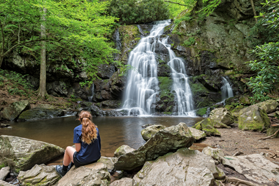 woman looking at waterfall